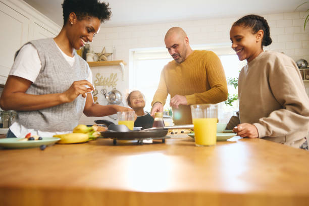 istock Family and boy with Down syndrome making pancakes for breakfast 1473857523