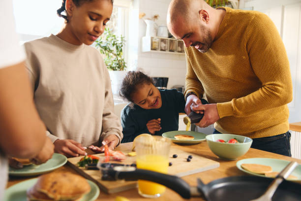 istock Boy with Down syndrome having pancakes for breakfast with family 1473857524