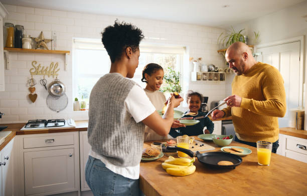 Family making pancakes for breakfast