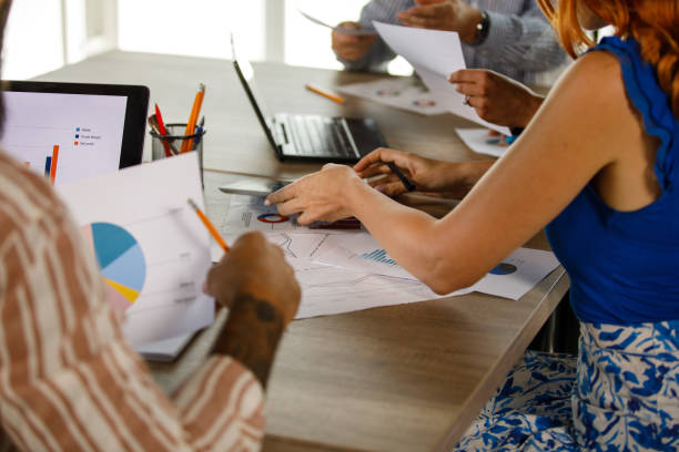 istock Group of business people analyzing documents during a meeting 1473859400