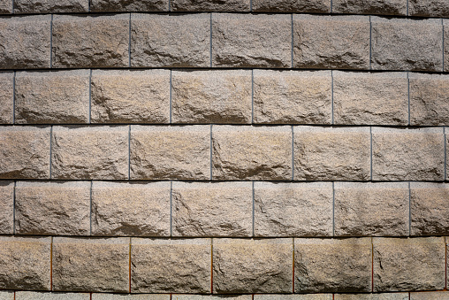 Close-up of beige stone wall texture background.