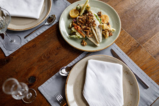 istock High angle view of fried fish and nuts on plate without people 1473860700