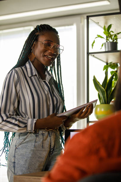istock Two business colleagues casually chatting about a mutual project 1473860844