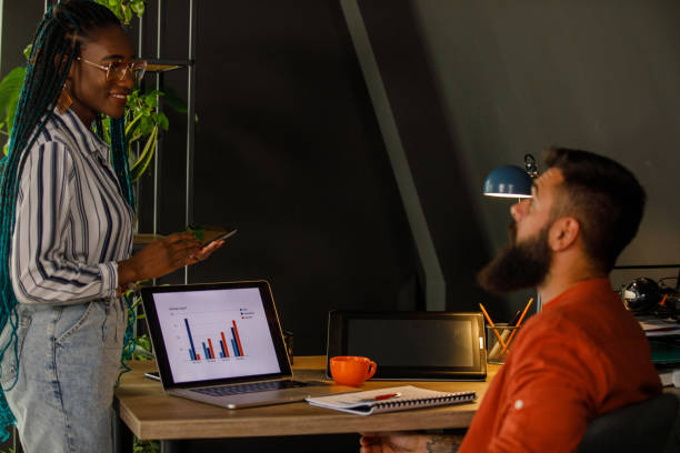 istock Two business colleagues casually chatting about a mutual project 1473860850