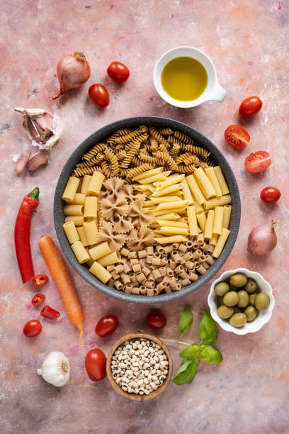 uncooked italian pasta of different shapes in a pan. - 2359 imagens e fotografias de stock