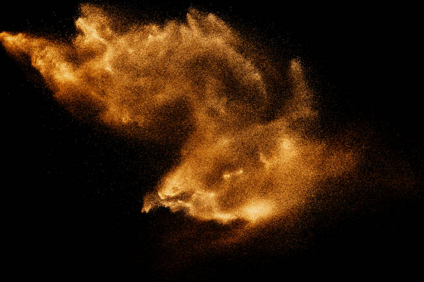 istock Dry river sand explosion. Brown color sand splash against black background. Yellow sand fly wave in the air. 1473861908