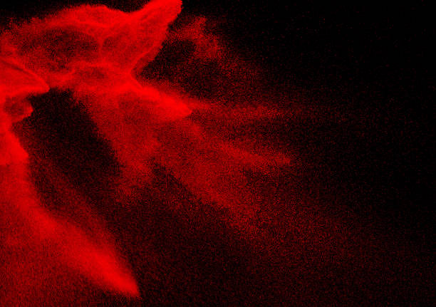istock Red particle explosion on black background.Freeze motion of red dust splash. 1473862484