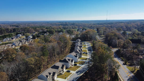istock Lush tree residential neighborhood with broadcast tower background in master planned community with underground utilities, row of two-story houses suburbs Atlanta, Georgia, USA 1473864209