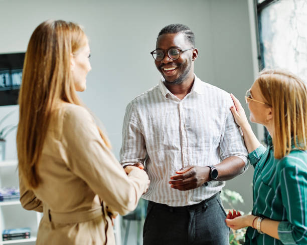istock young business people meeting office handshake hand shake shaking hands teamwork group contract agreement black happy smiling success partnership introduction greeting businessman man introducing 1473865716