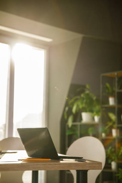 istock Sunny office and a tidy desk with open laptop 1473866188