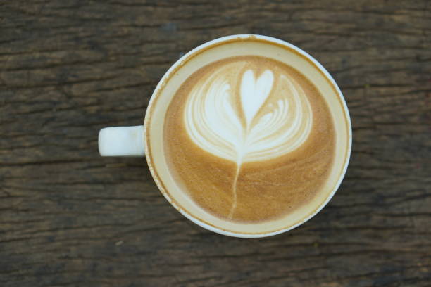 istock Flower shaped hot coffee placed on a wooden table 1473867603