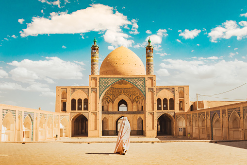 Kashan, Iran - 29th may, 2022: muslim woman pilgrim visit explore beautiful Agha Bozorg Mosque in sunny day
