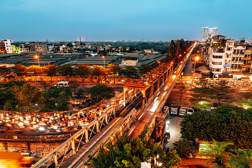 Hanoi, Vietnam - 11. November 2022:  Aerial View of Long Bien bridge over Hong (Red) river at dusk
