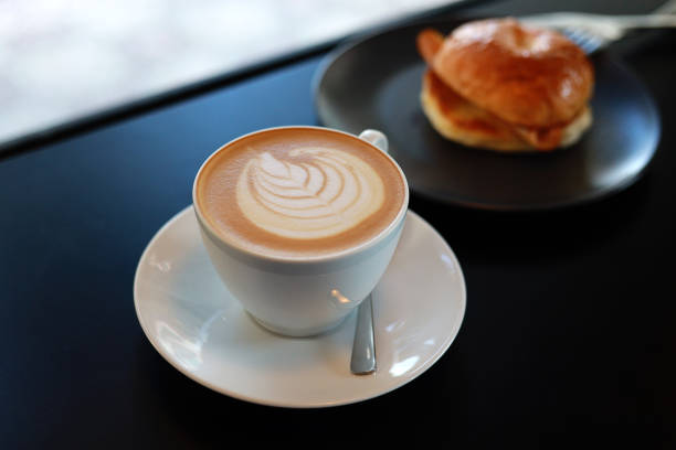 istock A cup of cappuccino latte and bagel on table 1473868801
