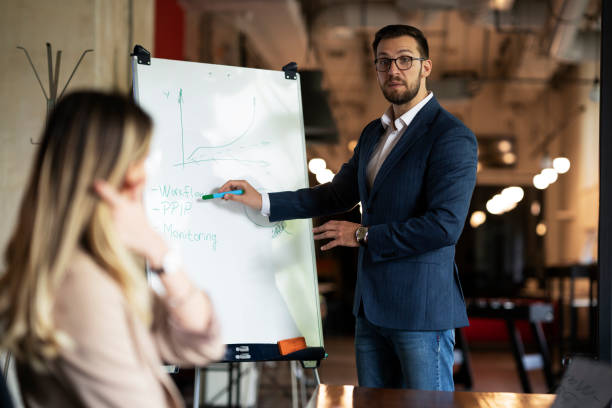 istock Young handsome man presenting business plan. 1473868880