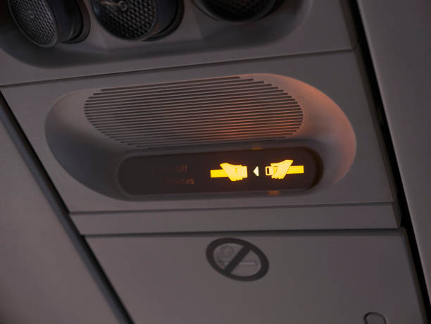 istock Light warning to fasten the seat belt on the plane 1473872243
