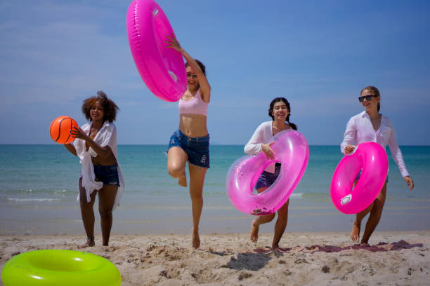 Teenage women travel on the beach. stock photo