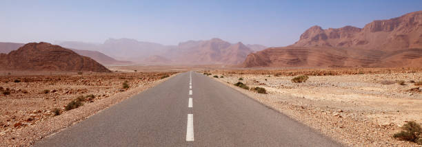 istock Road trip in Morocco- road in desertic landscape 1473876359