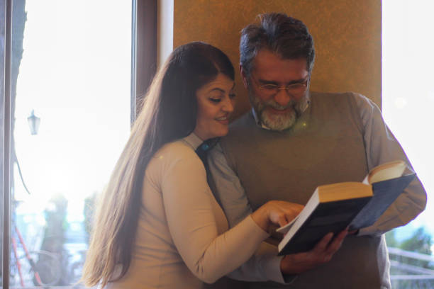 istock Couple in love reading book 1473876656