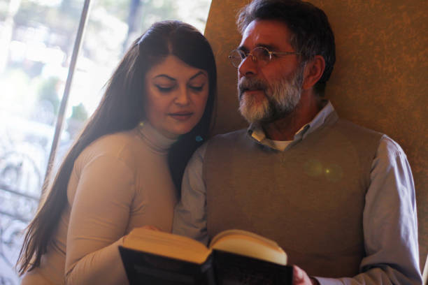 istock Couple in love reading book 1473876672