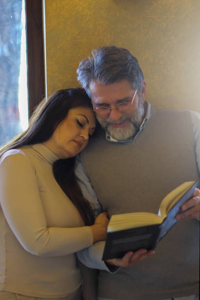 istock Couple in love reading book 1473876711