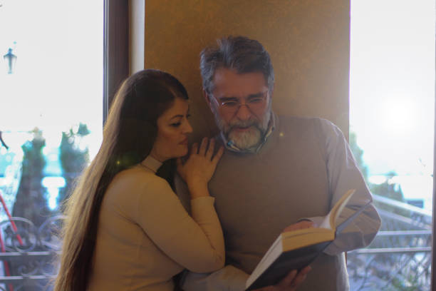 istock Couple in love reading book 1473876745