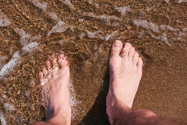 istock feet in the crystal clear sea 1473877892