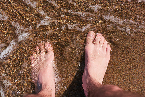 feet in the crystal clear sea