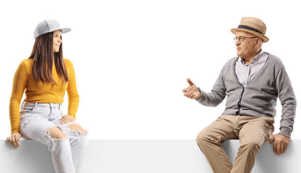 istock Elderly man talking to a gen z female and sitting on a blank panel 1473878162