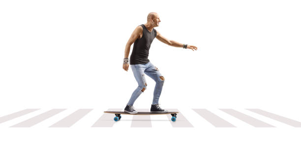 istock Male hispter riding a longboard at a pedestrian crossing 1473878972