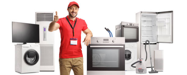 salesman with electrical appliances smiling and gesturing thumbs up - sale stok fotoğraflar ve resimler