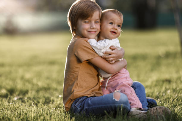 istock Happy siblings embracing in nature 1473879219
