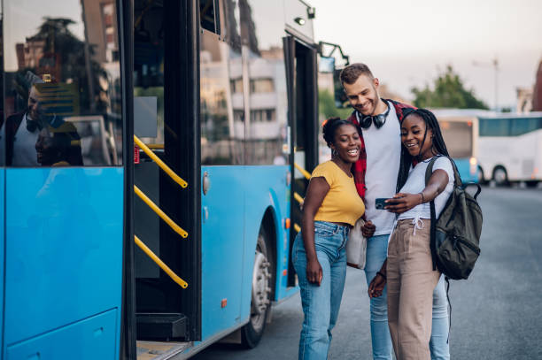 istock Multiracial friends taking selfie with a smartphone on a bus stop 1473882947
