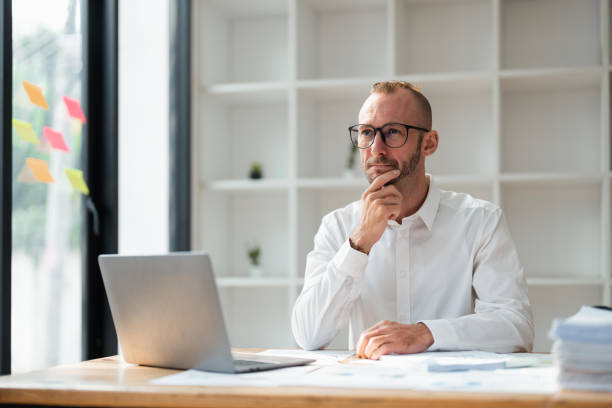 istock Image of young businessman analyzing work using a laptop at office 1473883098