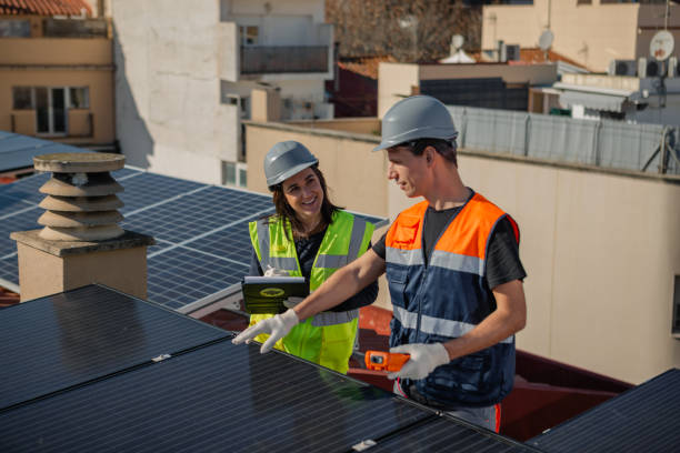 istock Engineers on roof for solar panels maintenance, inspection or installation 1473884838