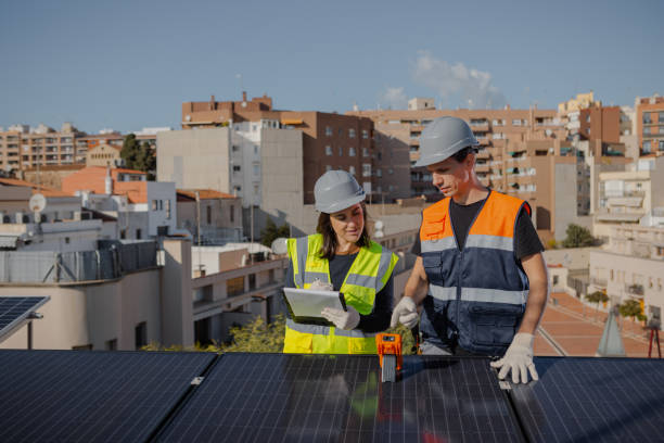 istock Engineers on roof for solar panels maintenance, inspection or installation 1473884924
