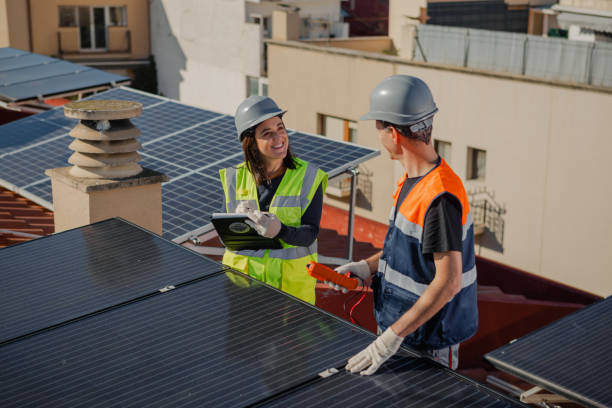istock Engineers on roof for solar panels maintenance, inspection or installation 1473884945