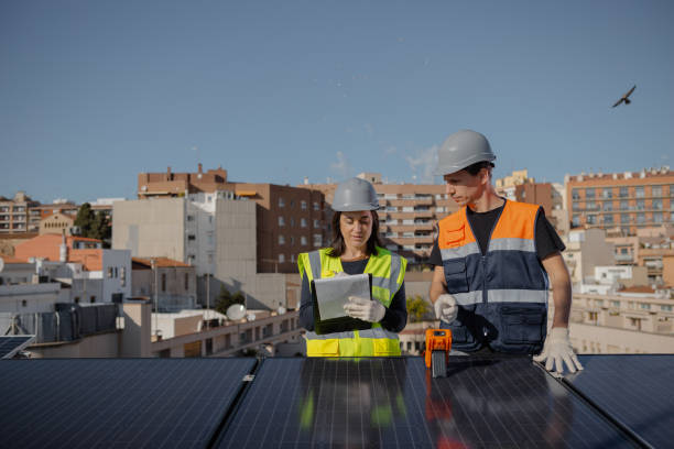 Engineers on roof for solar panels maintenance, inspection or installation