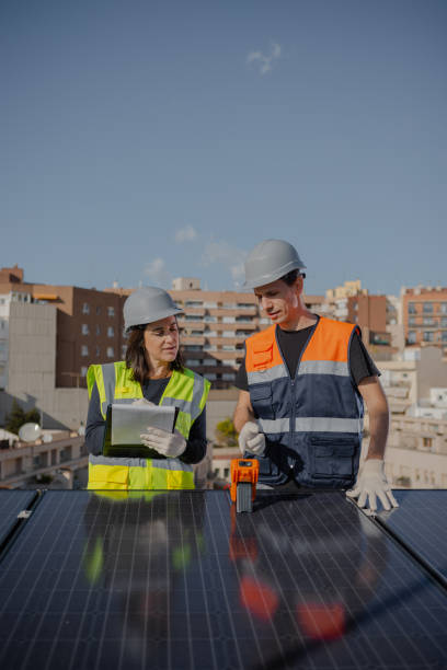 istock Engineers on roof for solar panels maintenance, inspection or installation 1473885695