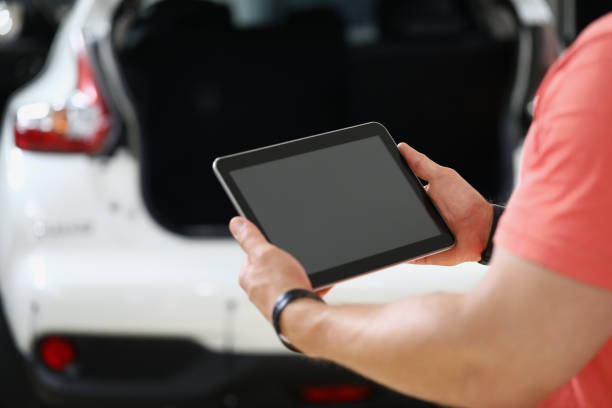 istock Rear view of worker holding tablet and checking machine 1473885870