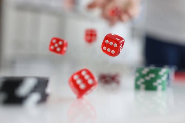 istock Person rolls dice and chips. Casino game and luck 1473886223