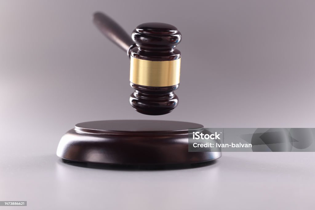 Wooden gavel for court or auction on gray background Wooden gavel for court or auction on gray background. Sentence verdict and procedural act of justice concept Auction Stock Photo