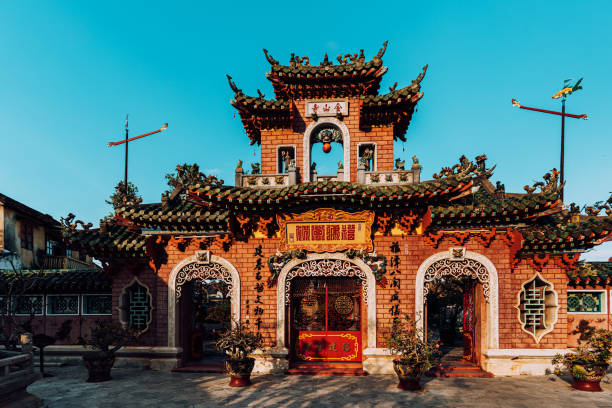 A male holding and lighting a group of incenses sticks to pray for good luck and a happy new year on December 31 at a Taoist temple in China.