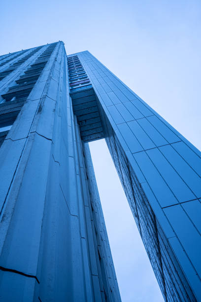 istock Exterior elevator shaft of a tall white high rise building.. 1473888136