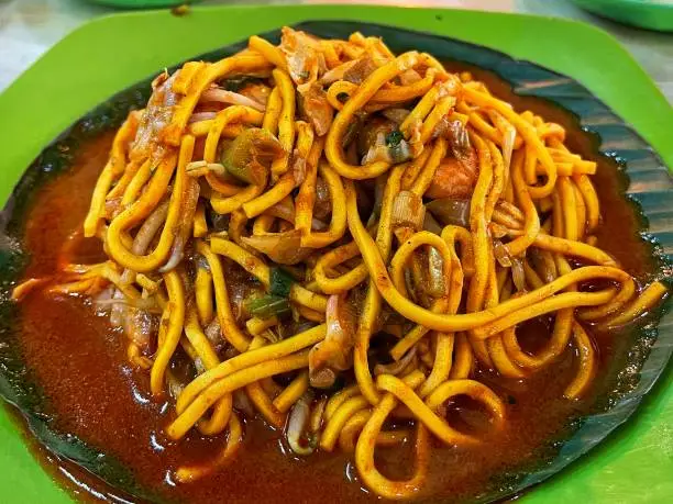 top view of spicy aceh noodles with shrimp topping