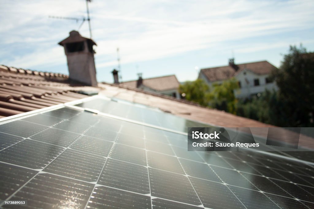 solar panels working at full capacity on a sunny day Solar panels on the roof of a single-family home generating renewable, green and clean electricity Solar Panel Stock Photo