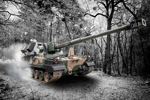 Modern self-propelled 155 mm Krab howitzer in a forest and winter scenery