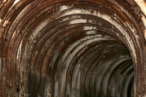 An old tunnel with an arched metal beams in mauntain