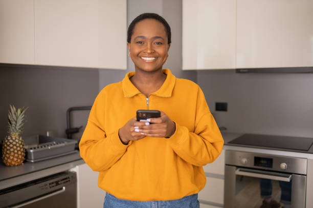 istock Happy young woman using phone 1473891429