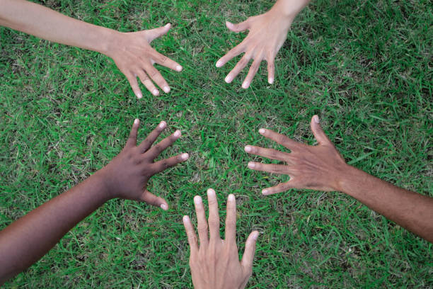 istock Diverse People Showing Hands Together in The Park 1473891517